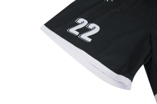 A black sports jersey featuring white details and the number 22, with a logo on the fabric.