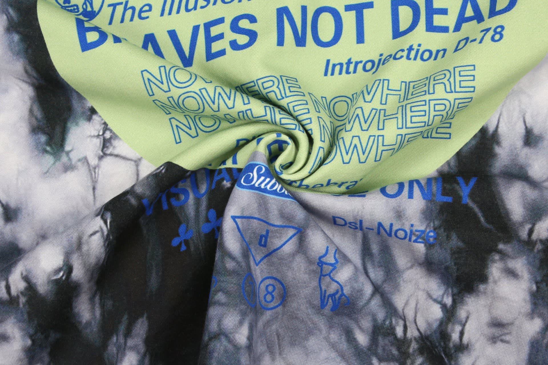 A cotton hoodie featuring vibrant graphic prints in green and blue on a tie-dye background.