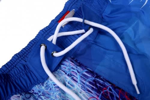Bright blue beach shorts featuring a vibrant abstract pattern and a white drawstring for an adjustable fit.