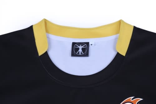 A black rugby top with yellow accents at the collar and a logo on the front. Features a tag indicating size 'M'.
