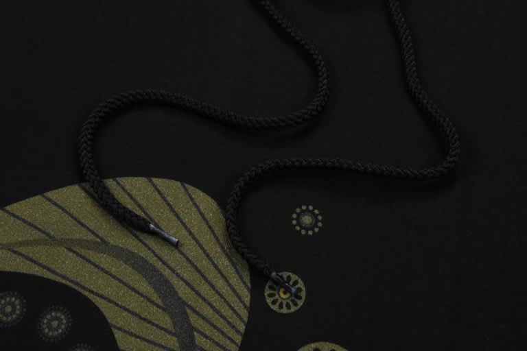 A black cotton sublimation hoodie featuring a textured design and a black drawstring.