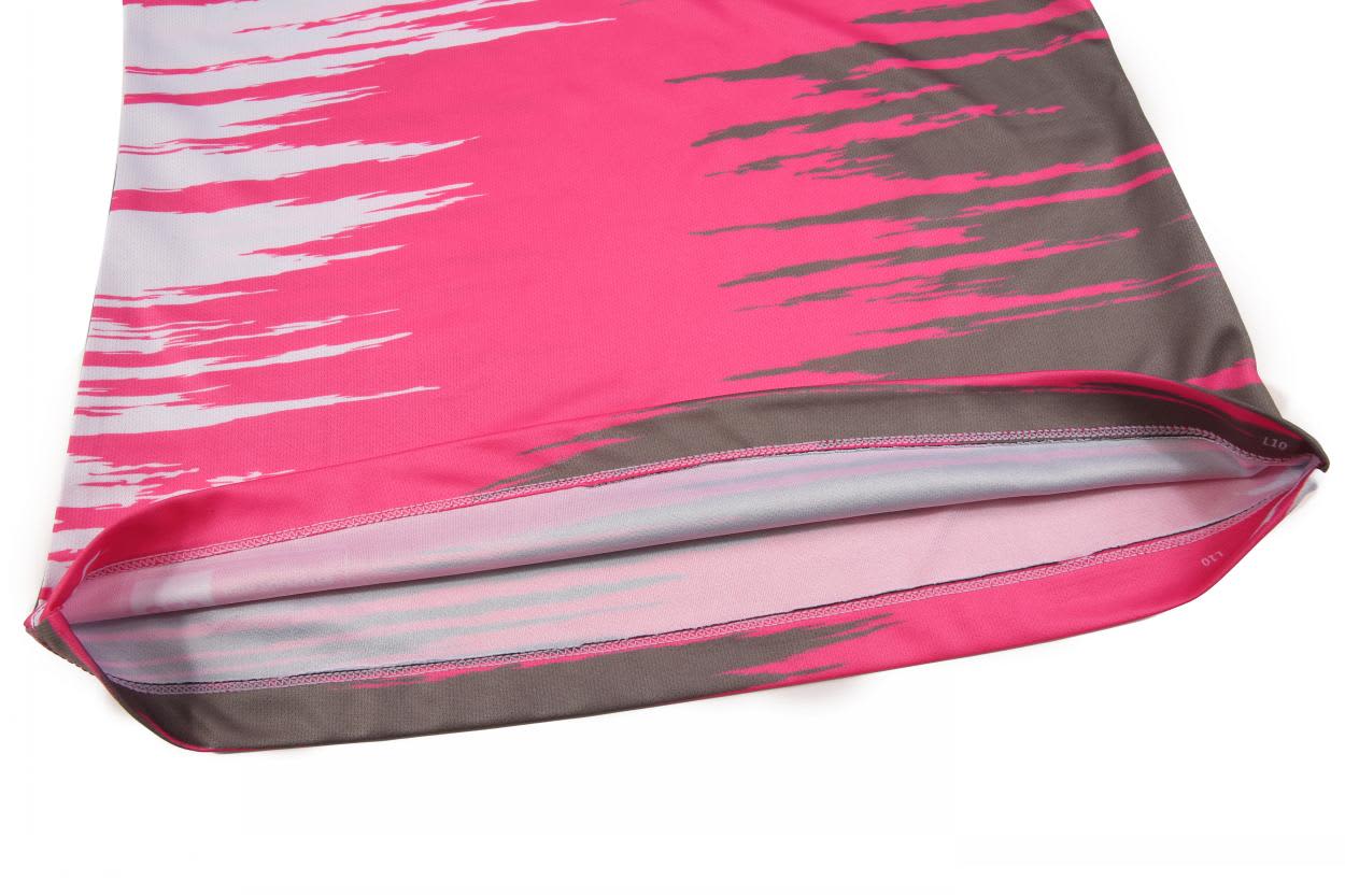 A pink racing singlet with a grey abstract pattern and a smooth finish at the hem. Features branding.