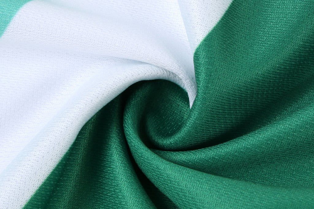A fabric swirl featuring green and white colours, possibly for a sports uniform. It has a branding logo.