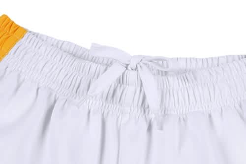 A white cricket uniform with an elastic waistband and a yellow detail, featuring a tie closure.