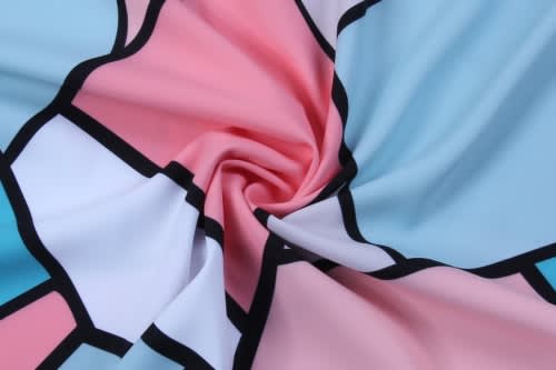 A swirl of fabric featuring pastel pink, blue, and white geometric patterns with black outlines, accompanied by a logo.