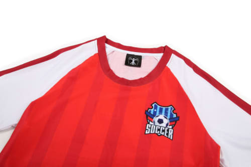 A red and white soccer jersey featuring vertical stripes and a logo on the front.