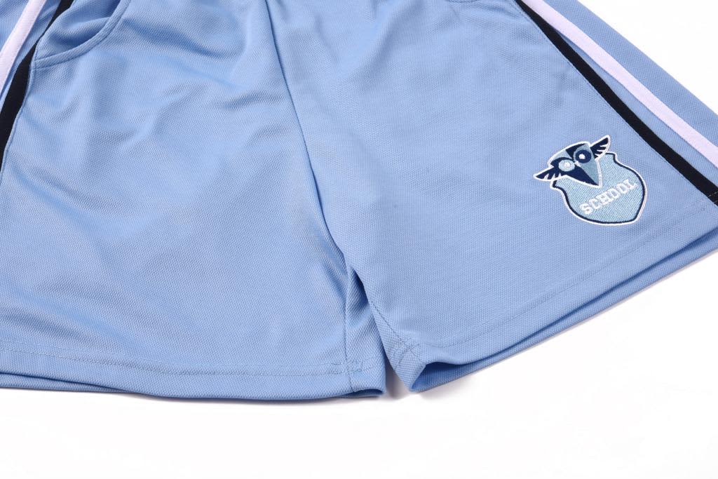 Cotton back shorts in light blue, featuring a logo on one leg and contrasting black stripes.