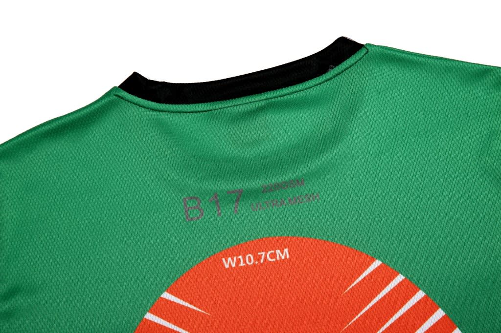 A green esports T-shirt featuring a round graphic design and a logo on the back neckline.