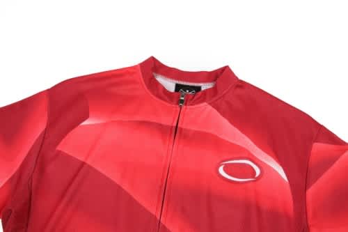 A bright red cycling uniform with a zip, featuring a logo on the upper left side.