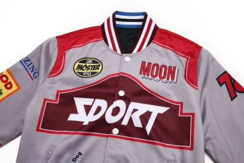 A reversible varsity jacket in grey and burgundy with striped collar and logos.