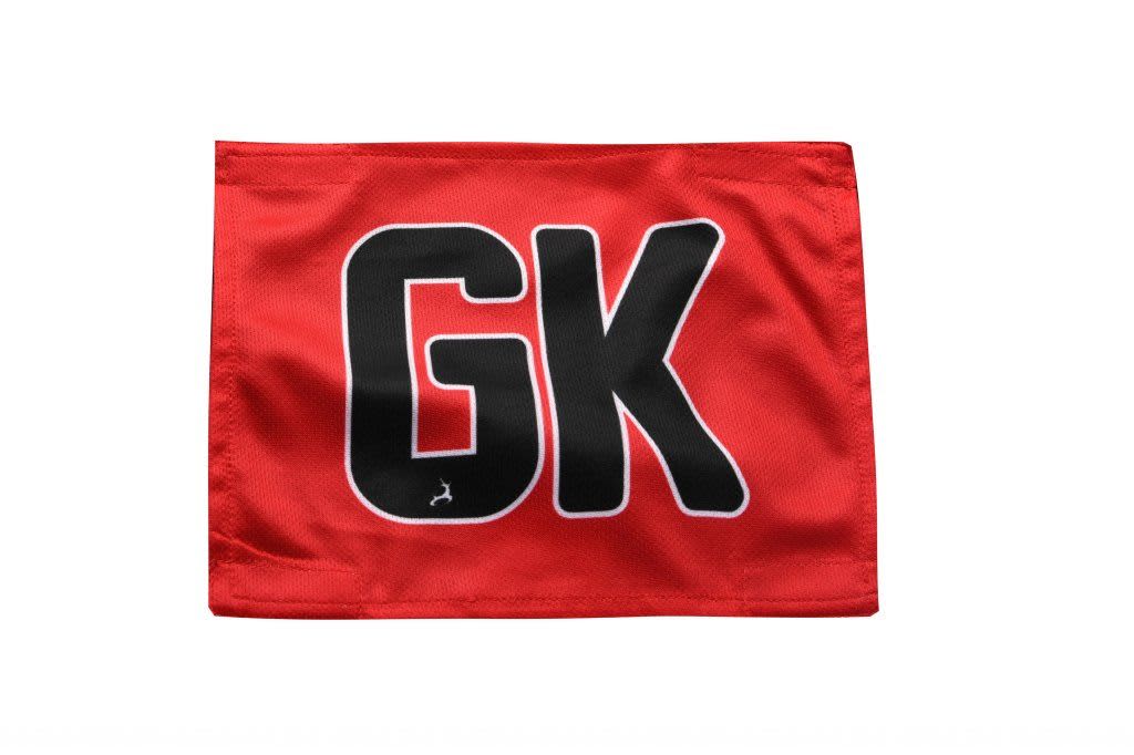 A red netball bib featuring the initials "GK" in large black letters. It includes a logo in the corner.