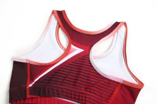 A women's athletics uniform in shades of red with a sporty design and a logo.