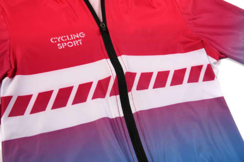 A cycling jersey featuring a gradient of red to cyan with a white stripe design and a logo.