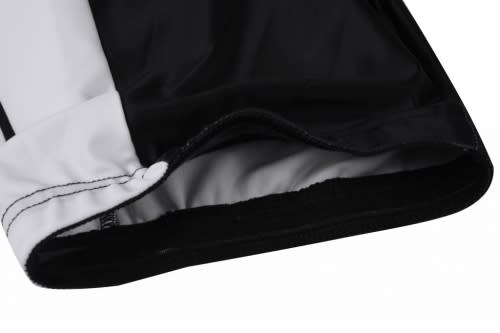 A close-up of a black and white bicycle jersey featuring a hem with stitching details and a logo.