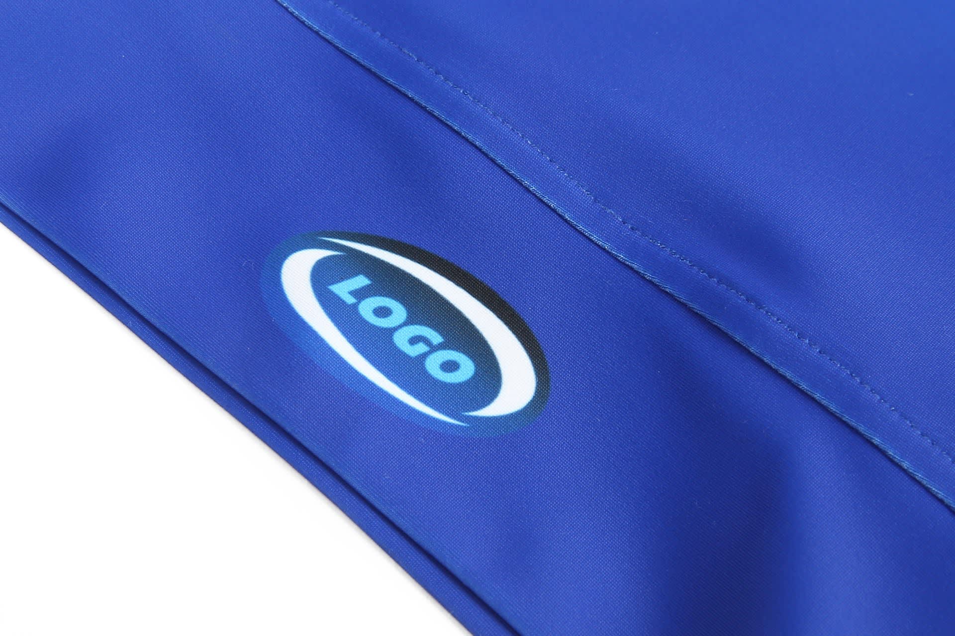 A close-up of a blue athletic uniform tight featuring a logo on the fabric.