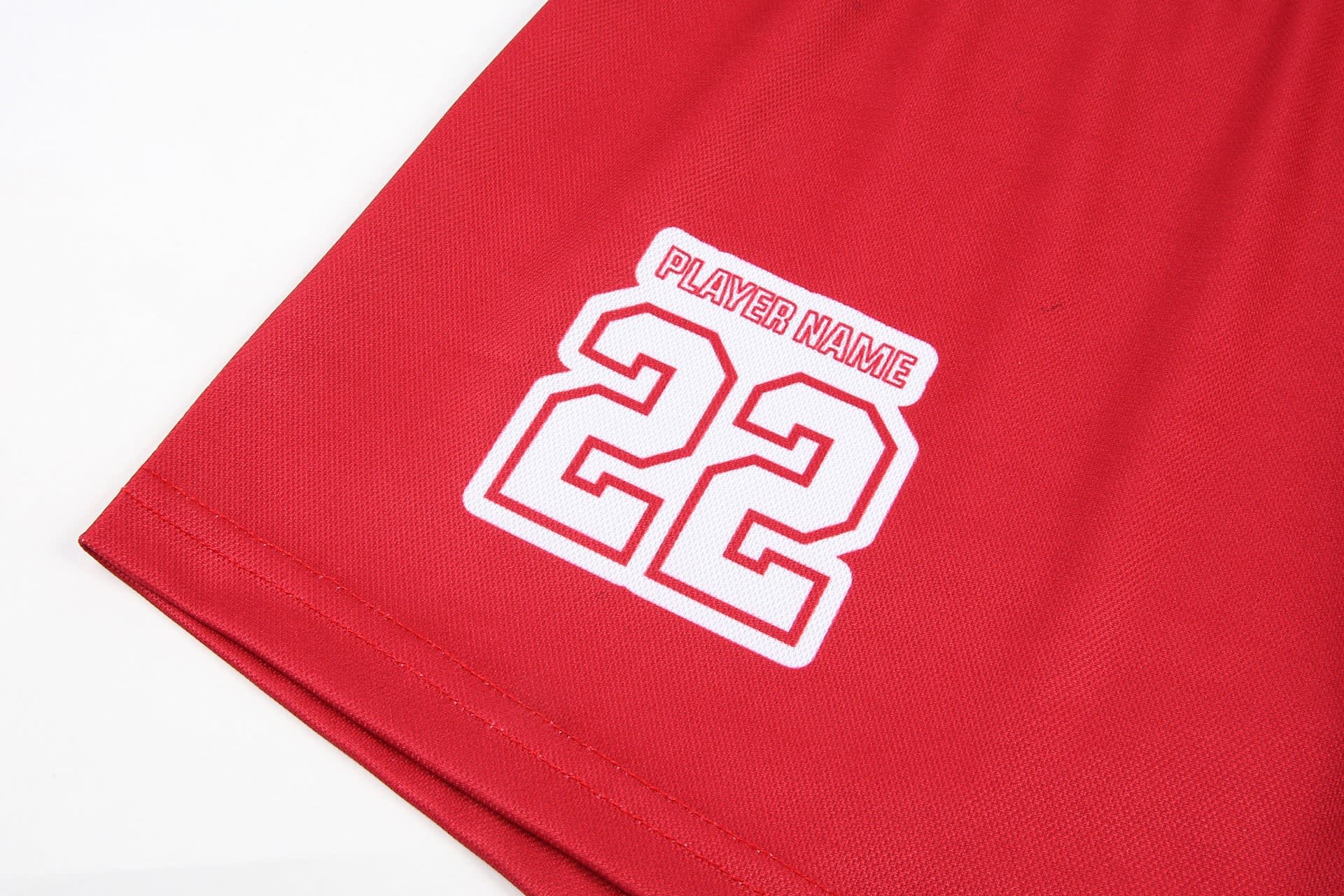 Red women's basketball shorts featuring a logo and a number "22" in white.