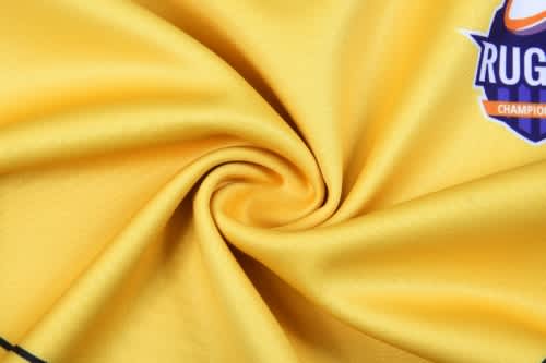 A smooth, yellow fabric with a logo in the corner, showing a spiral pattern.