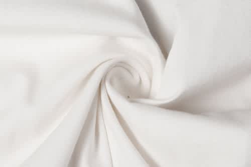 A folded piece of white fabric with a smooth, textured surface, showcasing its softness and subtle sheen.