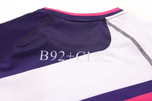 A sports jumper in navy, white, and pink, featuring a logo and anti-chlorine fabric.