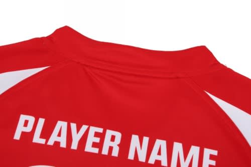 A red rugby jersey with white accents and a logo, featuring a blank player name area on the back.