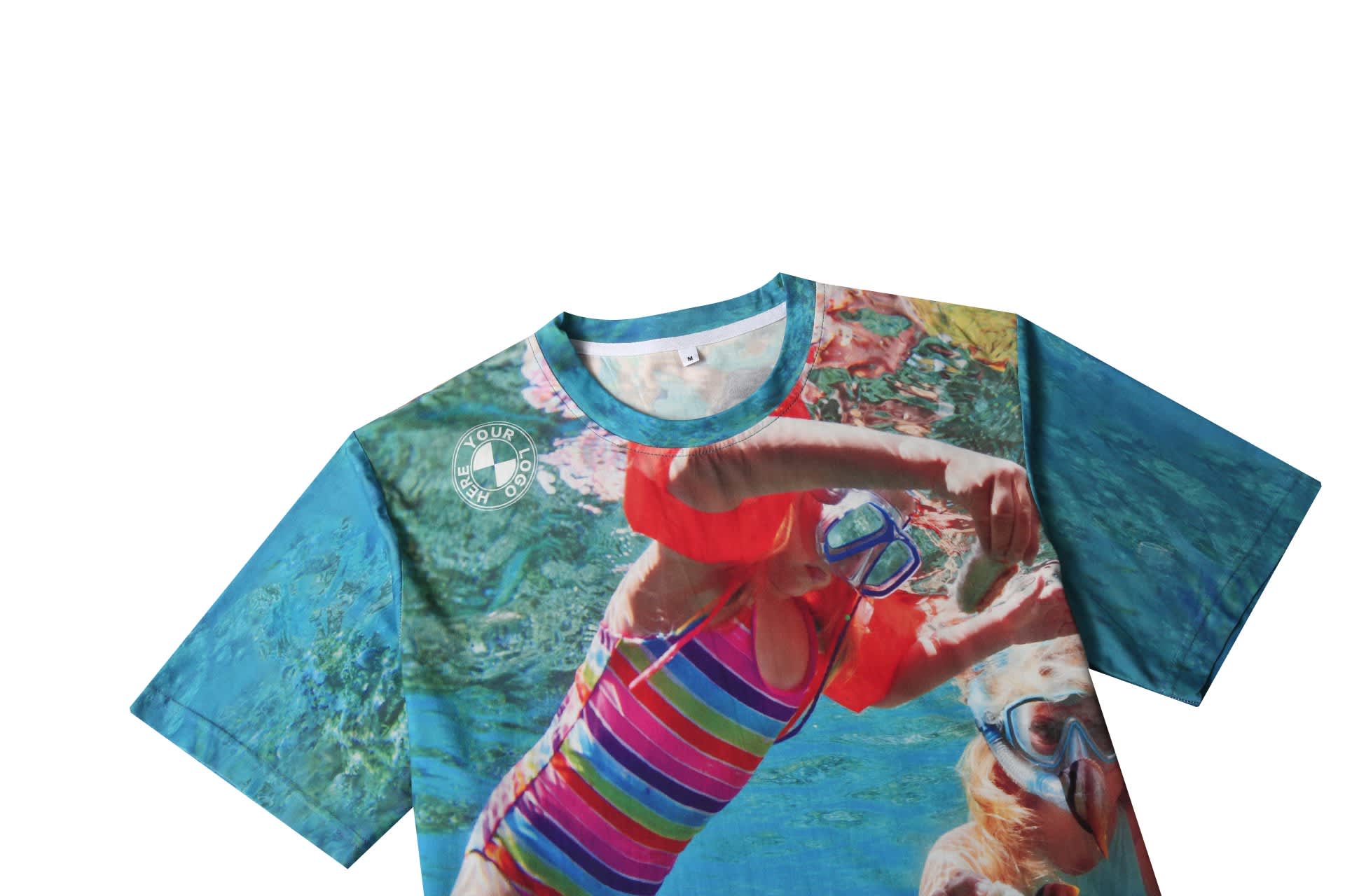 A vibrant cotton tee featuring a colourful underwater swimming design with hues of blue and pink. It has a logo on the sleeve.