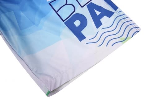 A beach shirt and shorts featuring a blue and white design with abstract patterns and a logo.