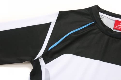 A sports uniform in black and white with blue accents, featuring a logo on the collar and long sleeves.