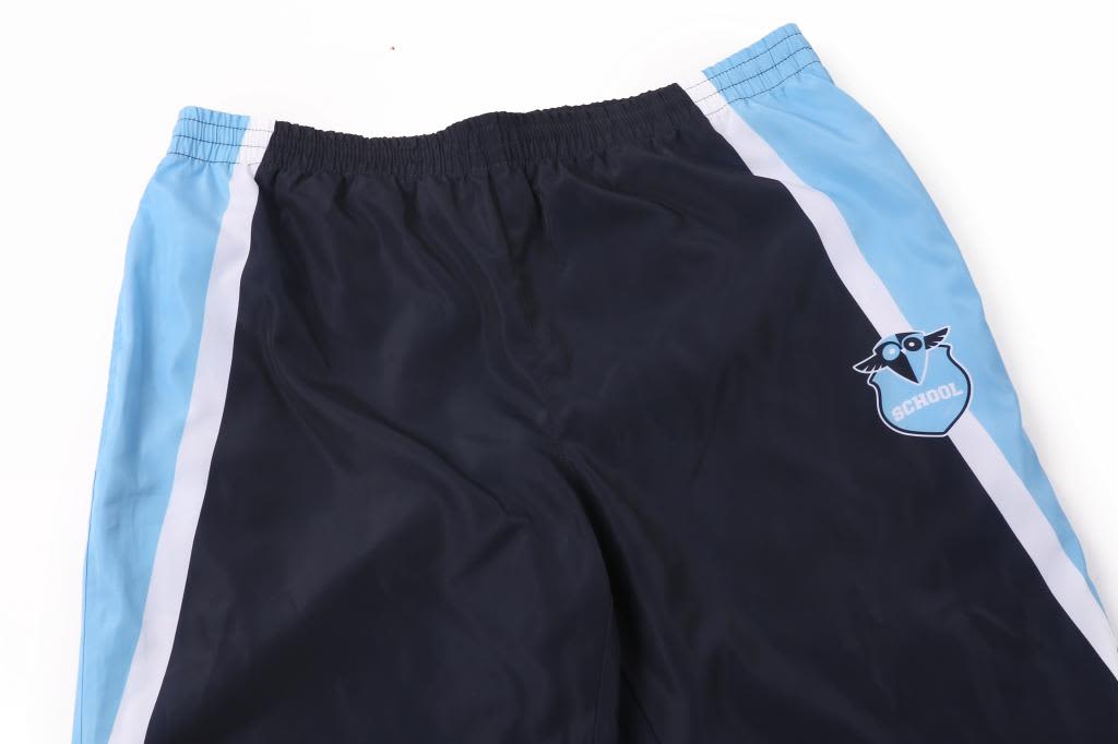 Zip bottom lining pants in navy blue with light blue side stripes and a logo on the front.