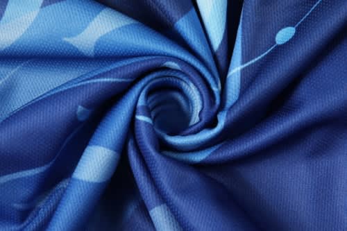 A blue fabric with a swirl pattern featuring varying shades of blue, designed for sports uniforms.