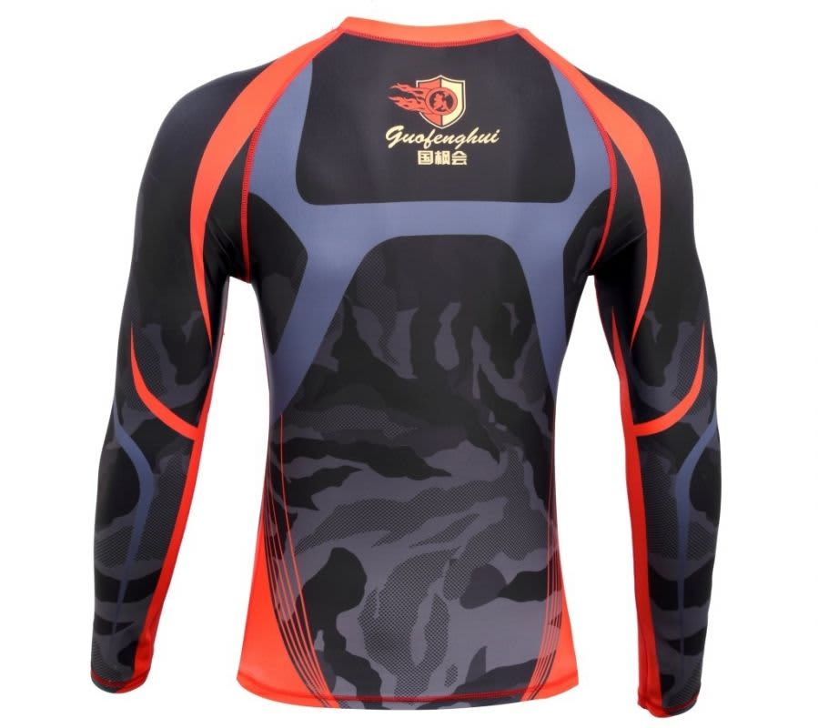 A long-sleeve compression tee featuring a black and grey camouflage design with red accents and a logo.