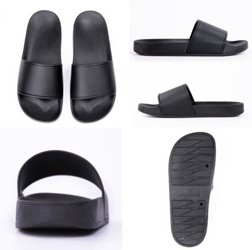 Black slippers featuring a simple design with a flat sole and a wide strap. Contains a logo on the side.
