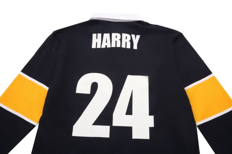 A black sports jumper featuring a white and gold collar, with the name "HARRY" and the number "24" on the back.