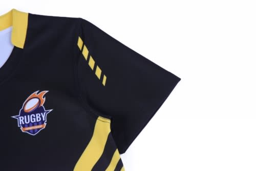 A black rugby top featuring yellow stripes and a logo on the chest.