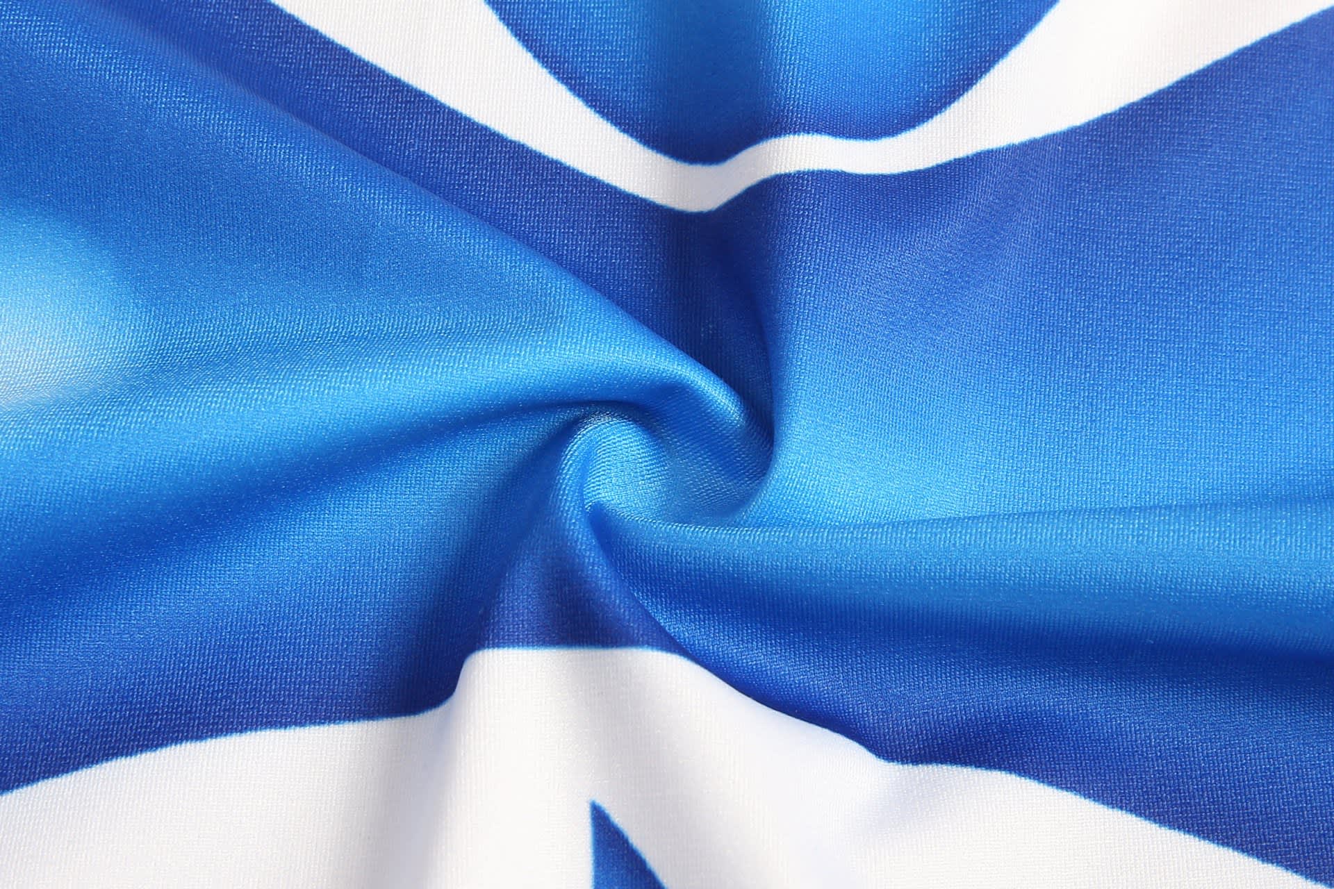 Blue and white fabric featuring a spiralled design, with a smooth texture and a subtle sheen.
