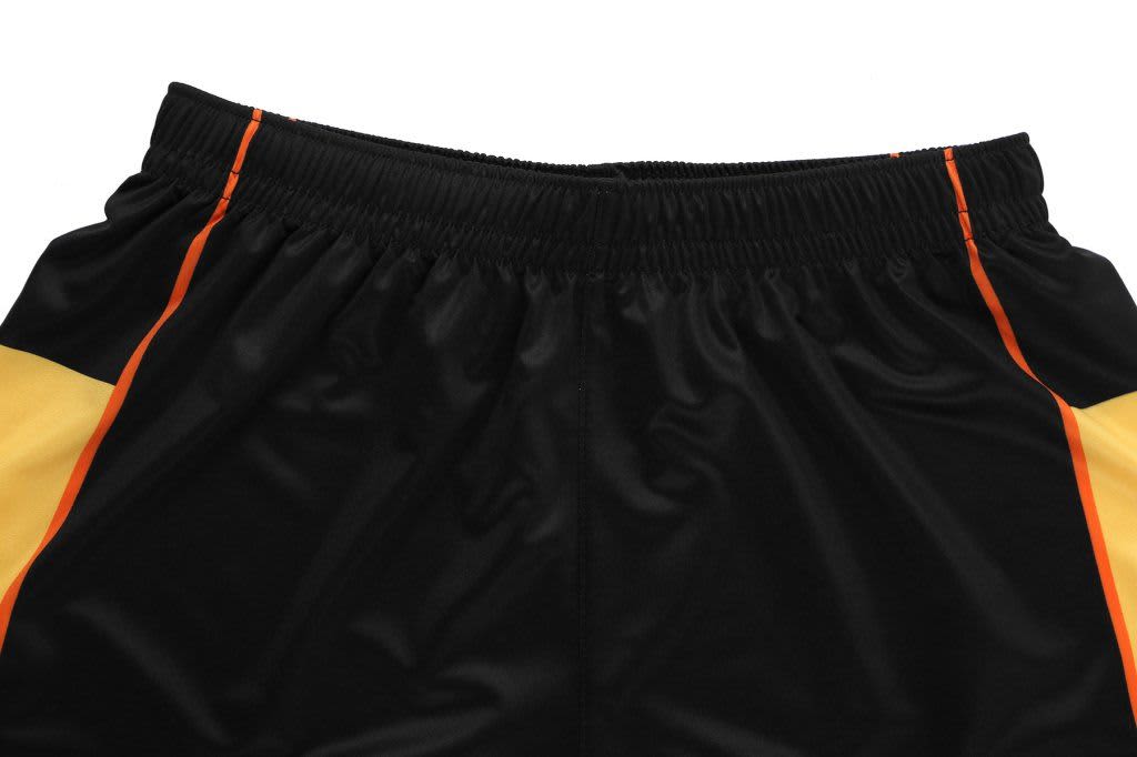 Black training shorts with yellow and orange accents, featuring an elastic waistband and a logo.