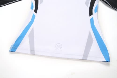 A sports uniform featuring a predominantly white design with blue and black accents, and a logo at the bottom.