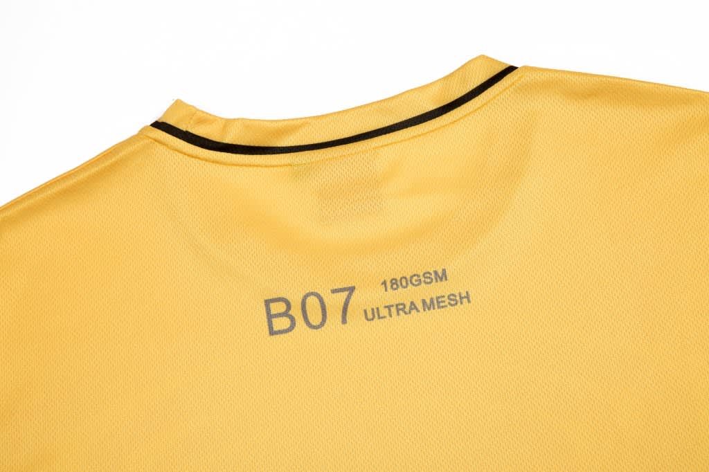 A yellow custom fan wear T-shirt featuring a mesh fabric and a back collar design. It has a logo on the neck.