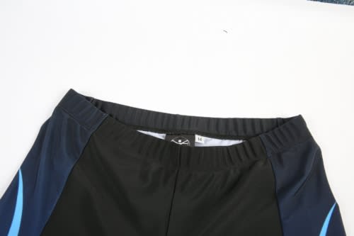 A pair of cycling shorts in black with blue accents, featuring an elastic waistband and branding inside.