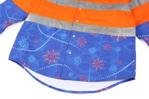 A Hi Vis shirt featuring a vibrant orange and blue design, with reflective strips and a patterned lower section.