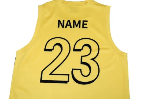 A yellow sports singlet featuring a large black number "23" and placeholder text for a name, with a logo present.