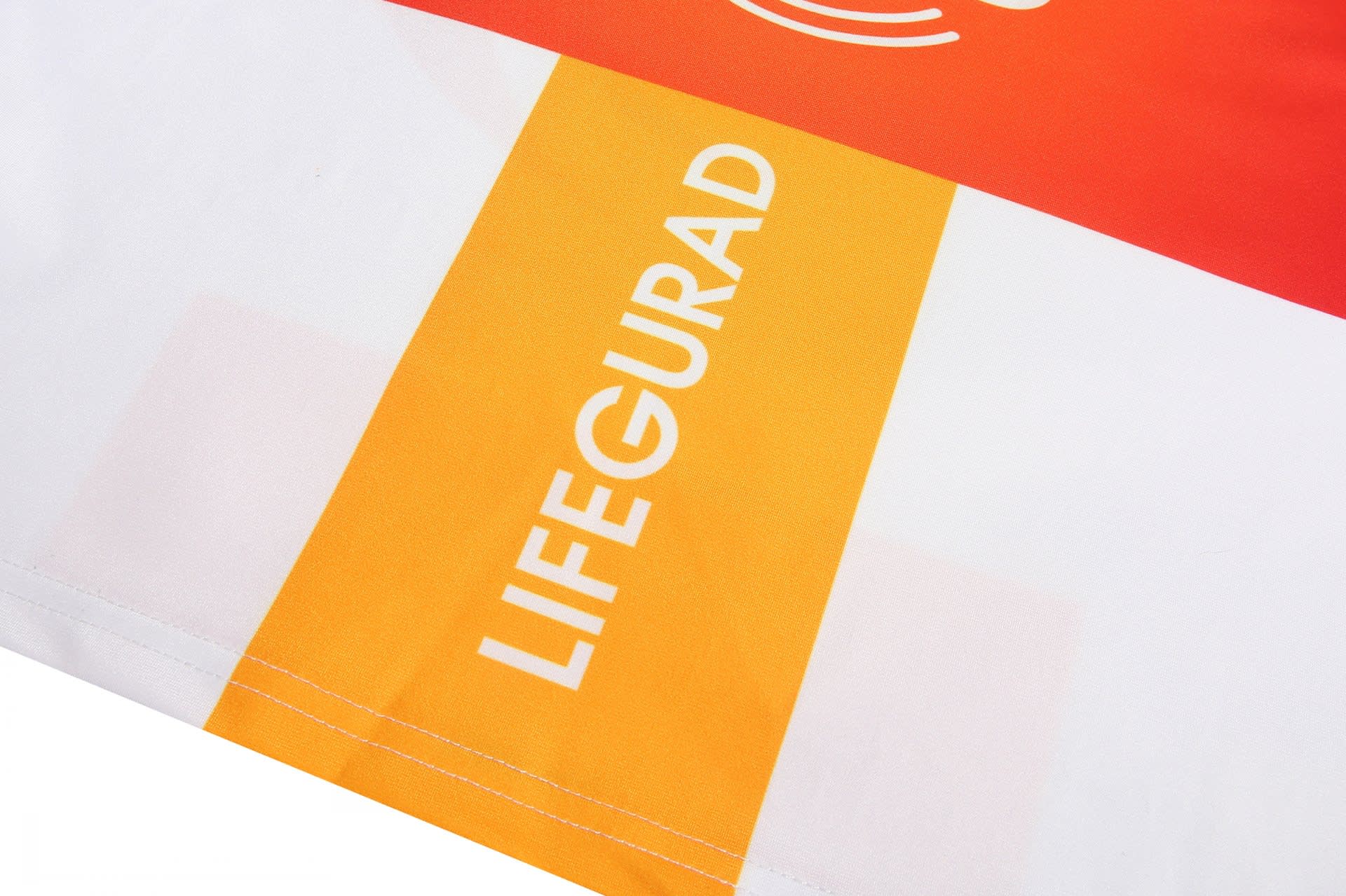 A swimming suit in white, orange, and yellow with a logo and the word "LIFEGUARD" prominently displayed.