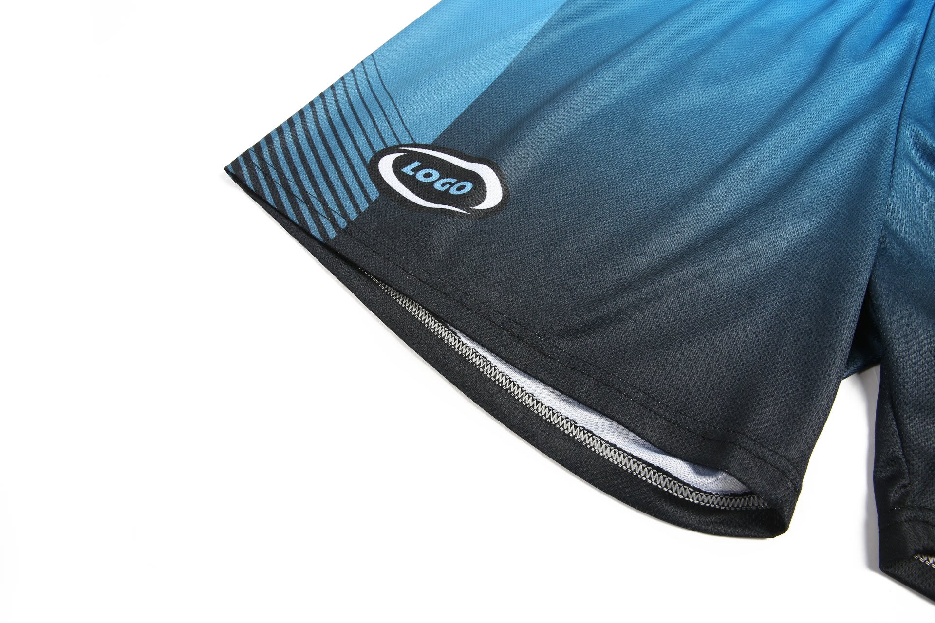 Shorts in shades of blue and black, featuring a logo on the lower hem.