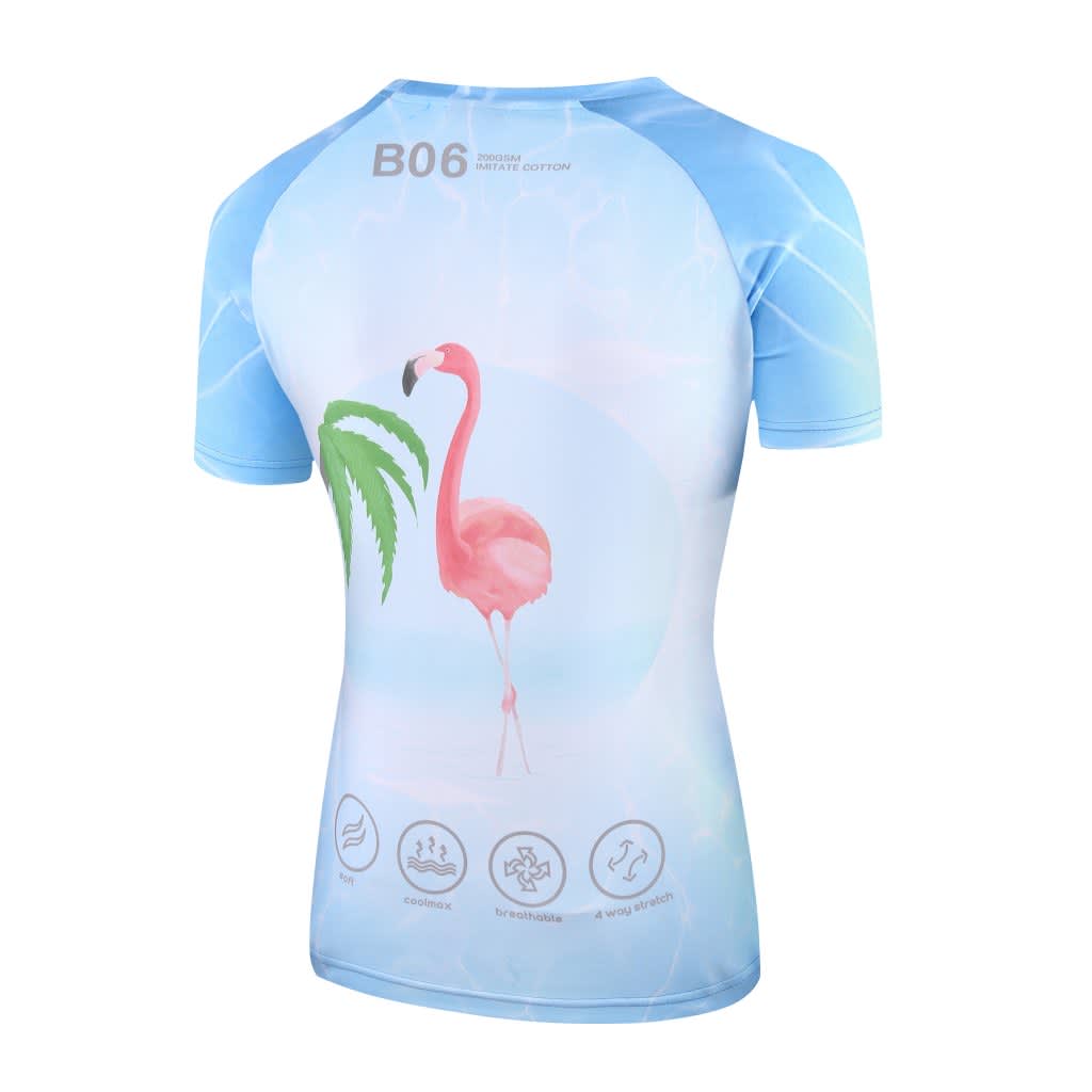 A women's tee featuring a light blue design with a flamingo and palm leaves on the back. It has a logo.
