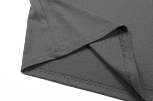 A grey cotton t-shirt featuring a folded hem, showcasing smooth fabric texture and stitching details.