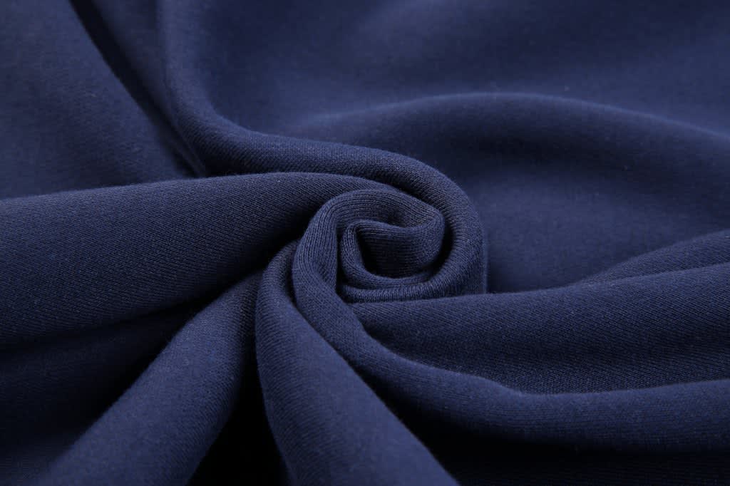 A close-up view of dark navy fleece fabric, showcasing its soft texture and smooth finish.