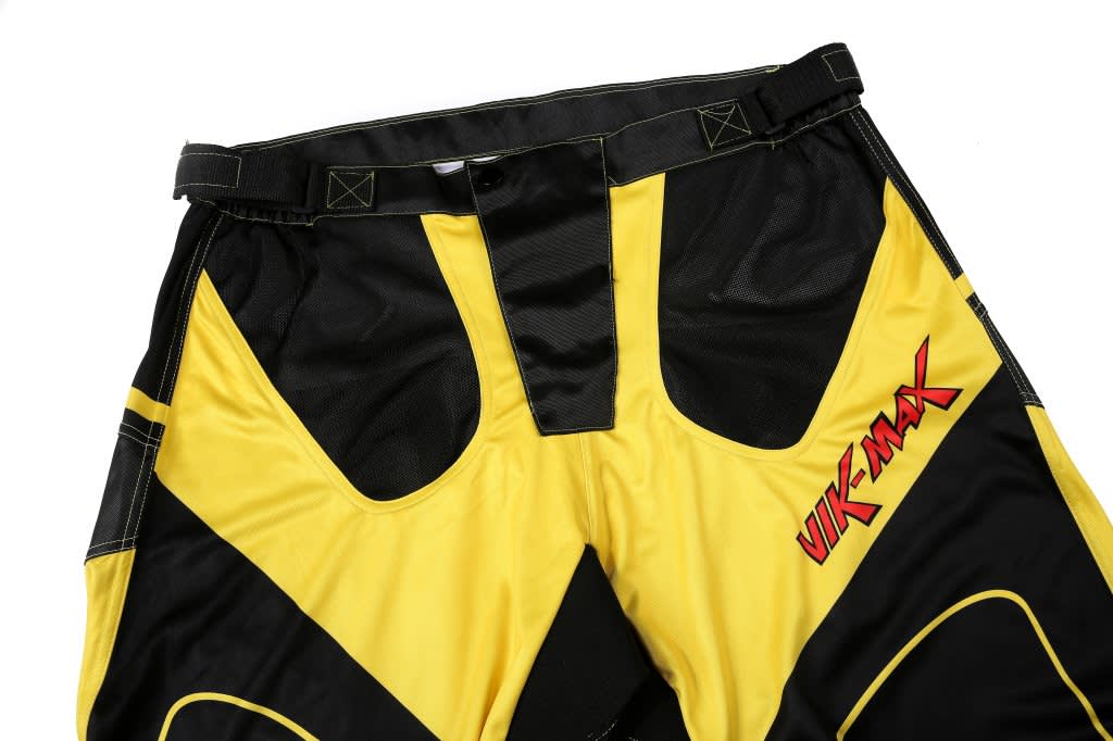 Ice hockey pants in black and yellow with a brand logo featured on the side.