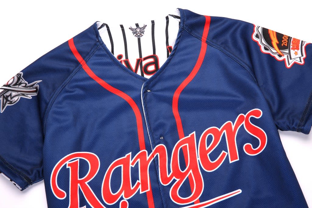 A navy blue baseball jersey featuring red lettering, a logo on one sleeve, and a button-up design.