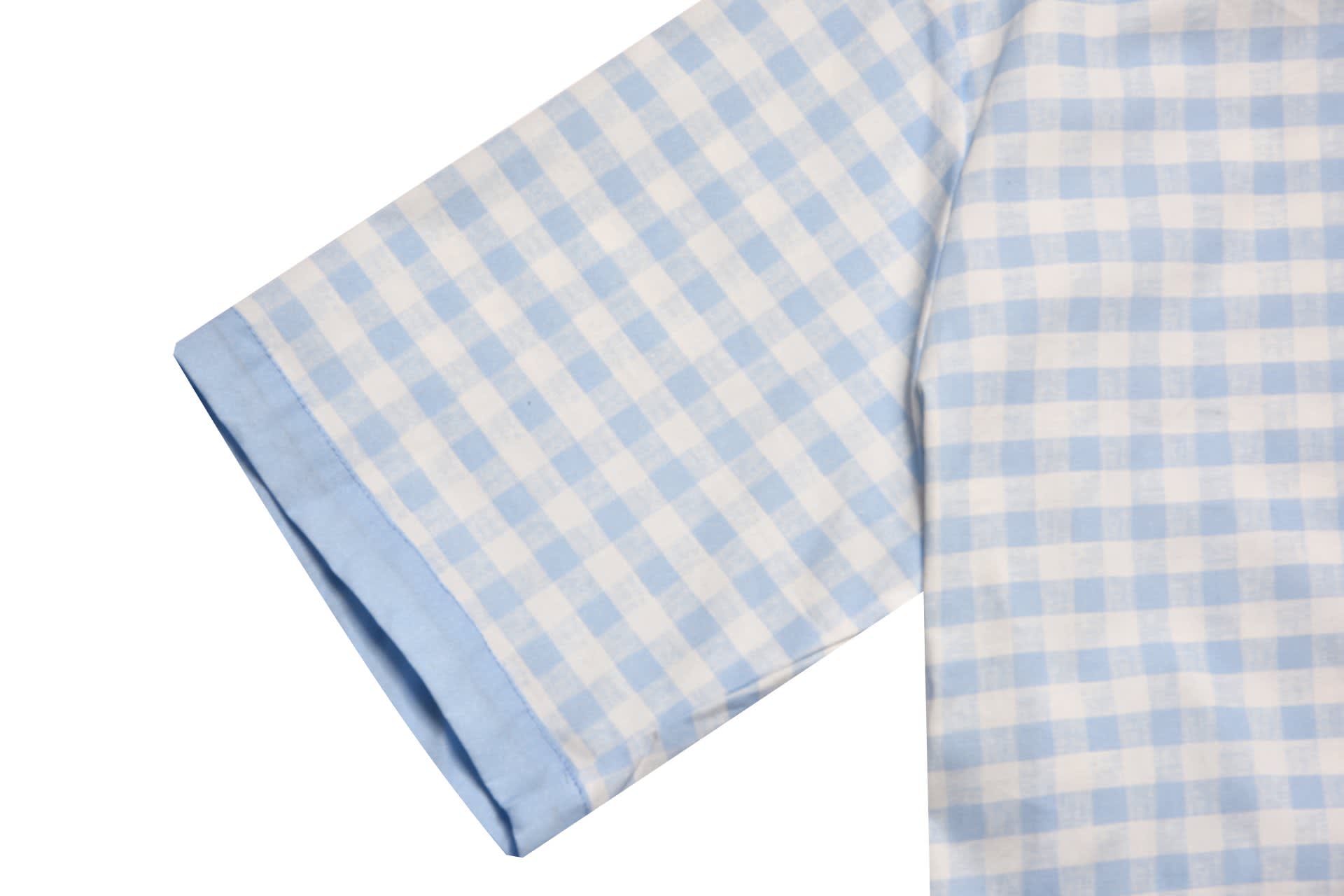 A light blue and white checked school wear shirt with a short sleeve and a cuffed finish. It features a logo.