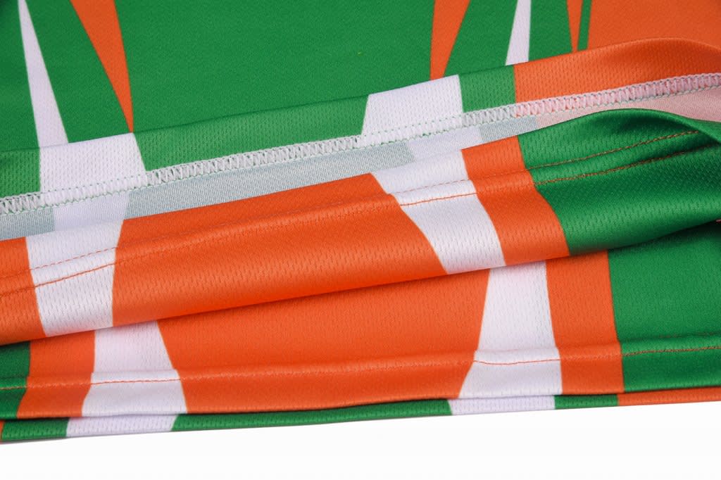 A reversible singlet featuring a vibrant green and orange design with white stripes. It has a smooth, soft fabric.