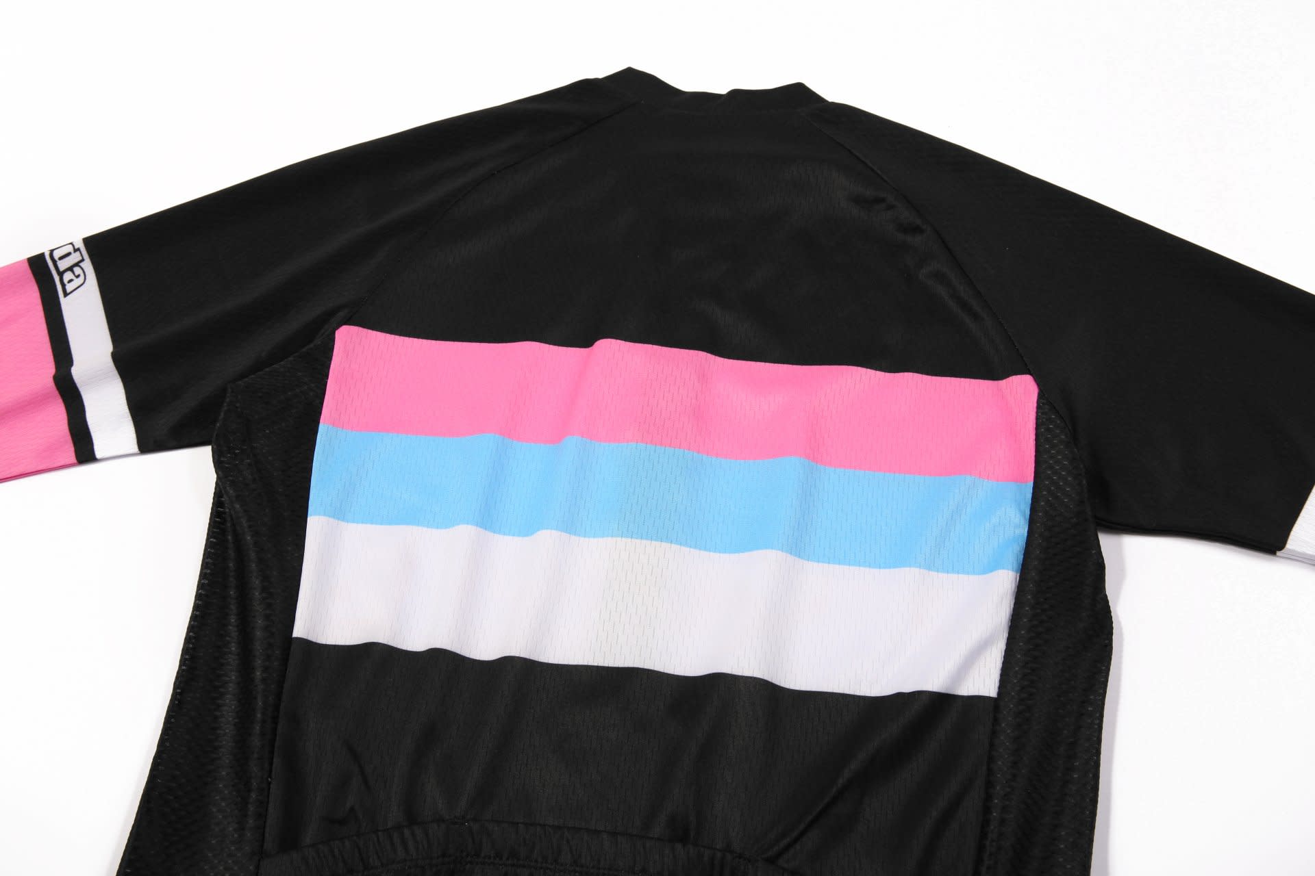 A black cycling racing top featuring pink, blue, and white stripes on the back, with a logo on the sleeve.